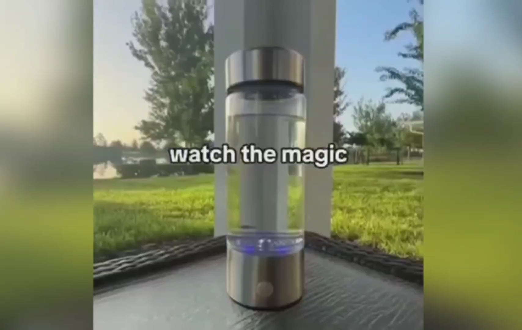 Promotional image for a hydrogen water bottle showcasing the product outdoors on a wooden surface with a green park backdrop. The video thumbnail features the water bottle with a caption overlay reading 'watch the magic' at the base, highlighting the transformative experience of using the product.